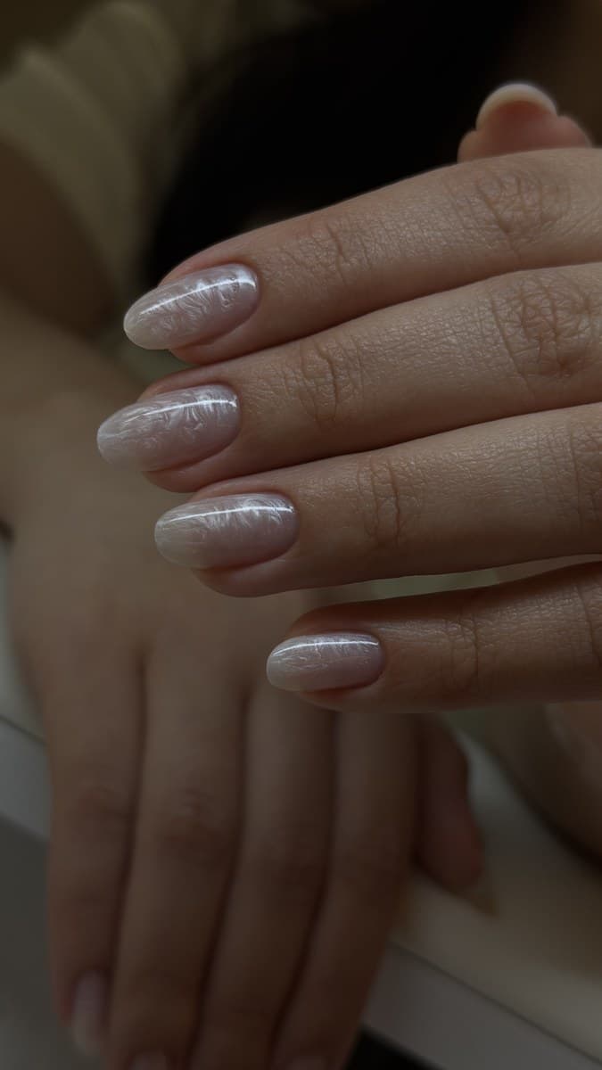 Silver glitter shimmer across almond nails.